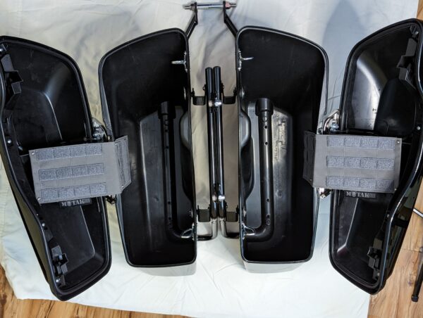 Open motorcycle saddlebags with TactiTether pouches mounted inside, showcasing organized storage